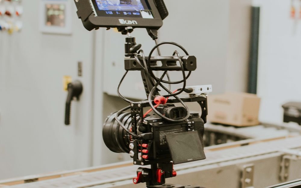 A professional cinema camera rig mounted on a slider in a studio